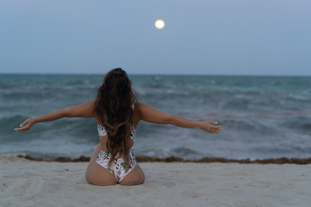 Tranquil beach yoga session under a full moon